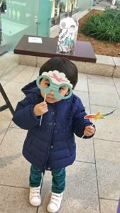 kid wearing mask toy airplane